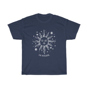 May include: A navy blue t-shirt with a white graphic of a sun with a face and stars. The text "LE SOLEIL" is printed below the sun.