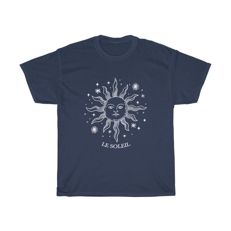 May include: A navy blue t-shirt with a white graphic of a sun with a face and stars. The text "LE SOLEIL" is printed below the sun.