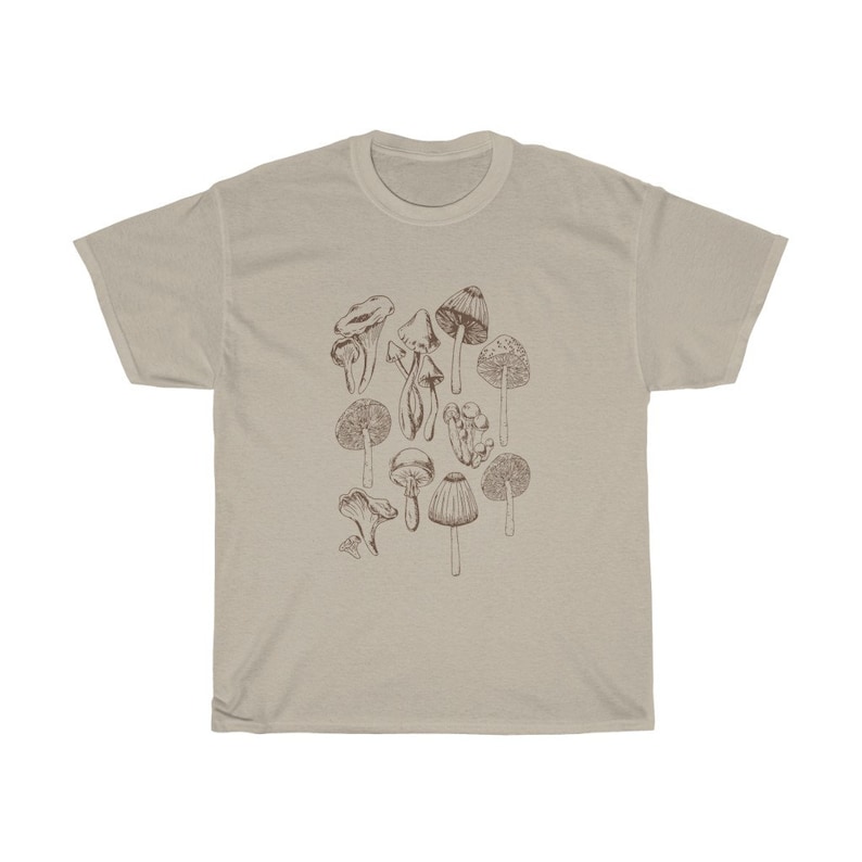 May include: A beige t-shirt with a brown line drawing of various mushrooms.