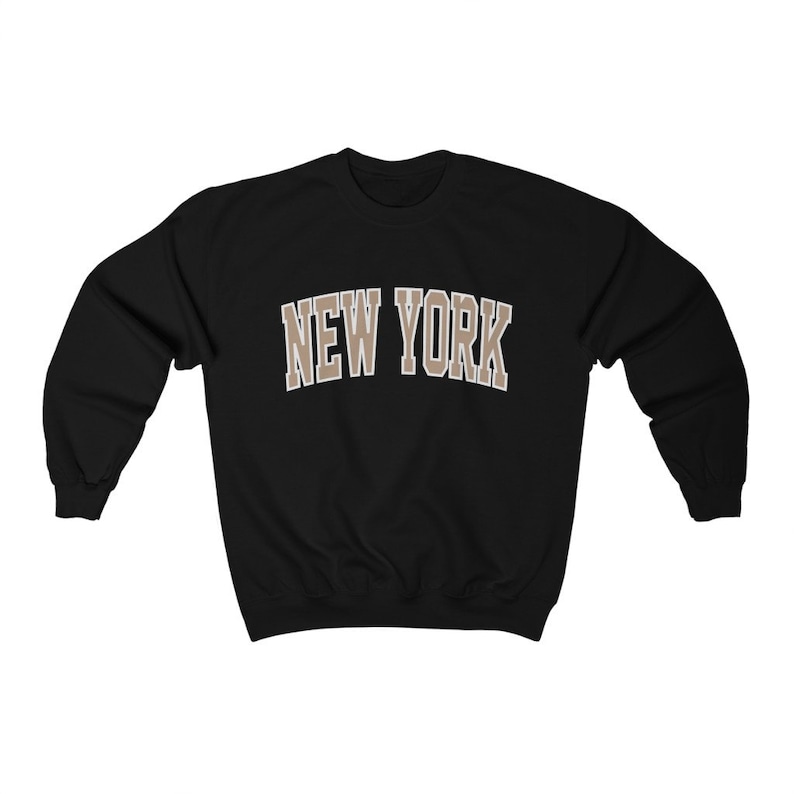 May include: Black sweatshirt with a brown "NEW YORK" graphic on the front.