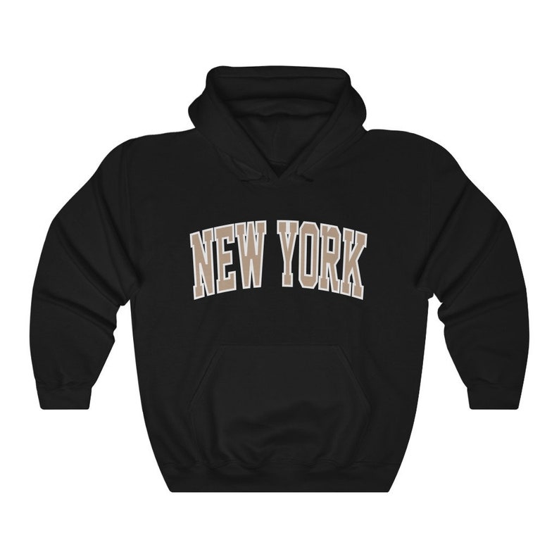 May include: Black hooded sweatshirt with the text "NEW YORK" in brown letters.