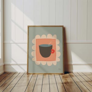 May include: A framed illustration of a brown cup with a red handle, filled with a blue liquid and a single steam rising from it. The cup is surrounded by a pink square with a white scalloped border, all on a light blue background.
