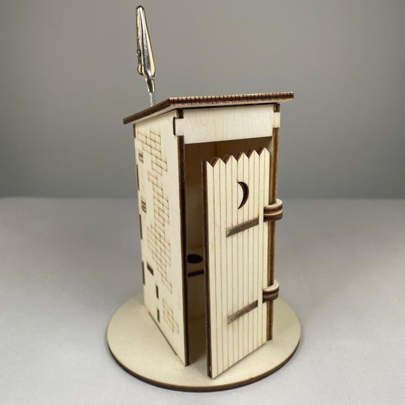 A personalized handmade wooden miniature outhouse/WC — the 'personalised bathroom humor' angle is genuinely niche, hand-crafted, and perfect for the white elephant player who has everything.