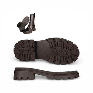 May include: A dark brown lace-up boot with a high shaft and a thick, lugged rubber sole. The image displays the boot from a side angle, a bottom view of the treaded sole, and a side profile of the heel and sole unit, showing a textured finish.