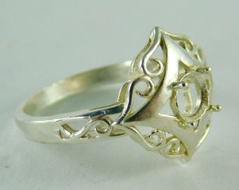May include: Silver ring with a filigree design and a setting for a large oval gemstone.