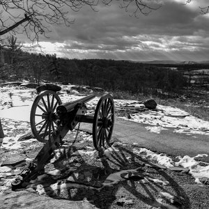 A black and white photo of a cannon on Little Round Top at the Gettysburg Battlefield where Civil War soldiers fought in July of 1863.