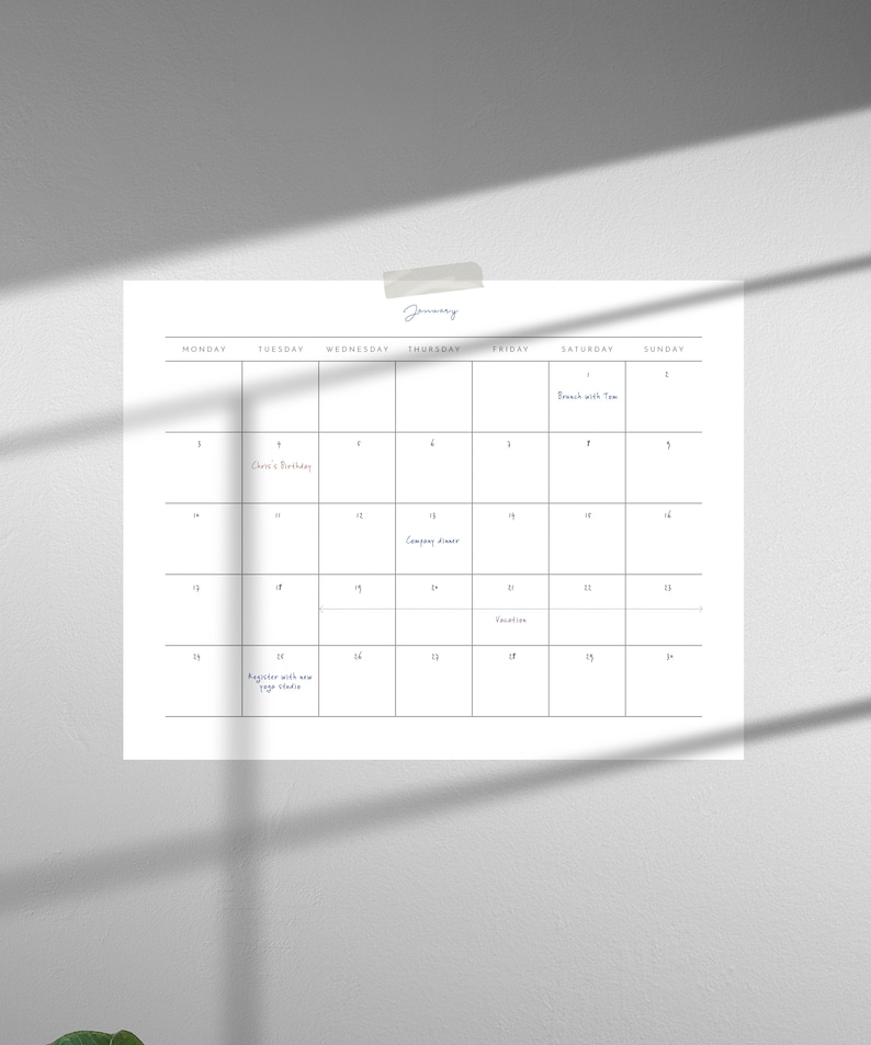 May include: A white calendar with black grid lines and handwritten text. The month of January is displayed with events such as "Company dinner", "Vacation", and "Register with new yoga studio".