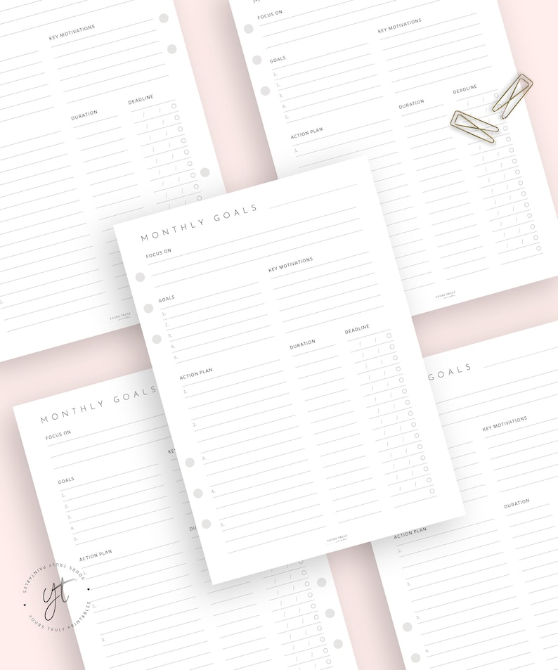 May include: A printable monthly goal planner with sections for focus, goals, key motivations, action plan, duration, and deadline. The planner has a simple, minimalist design with a gray and white color scheme.