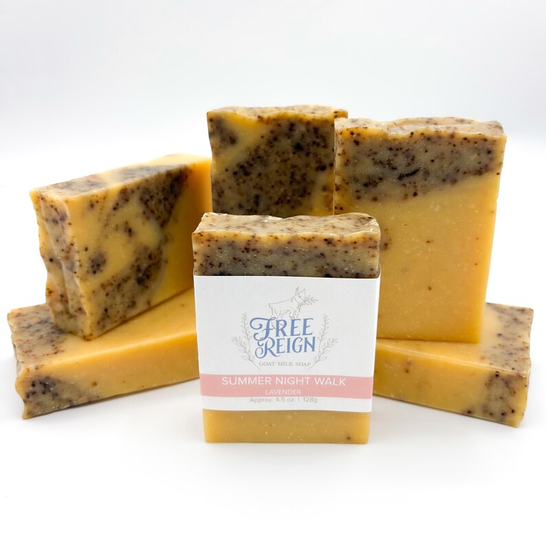 May include: A stack of six bars of goat milk soap with a label that reads "Free Reign Goat Milk Soap Summer Night Walk Lavender Approx 4.5 oz | 128g".