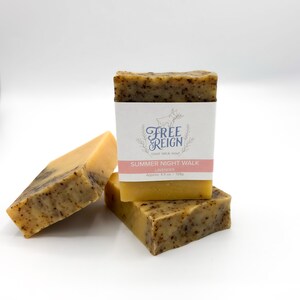 May include: Three bars of goat milk soap stacked on top of each other. The top bar has a label that reads "Free Reign Goat Milk Soap Summer Night Walk Lavender Approx. 4.5 oz. | 128g".