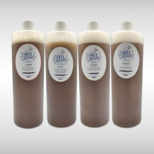 May include: Four brown plastic bottles of goat milk foaming soap with white labels. The labels have a logo of a goat and the text "Free Reign Goat Milk Foaming Soap". The bottles are labeled with the scents: Lavender, Cowboy, Spearmint, and Unscented.