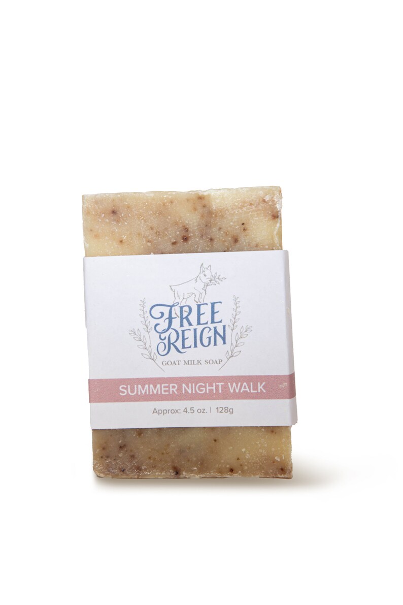 May include: A bar of goat milk soap with a white label that says "Free Reign Goat Milk Soap" and "Summer Night Walk" with the text "Approx. 4.5 oz. | 128g" below. The soap is a light brown color with flecks of brown throughout.