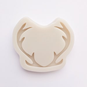 May include: A white silicone mold shaped like a deer head with antlers. The mold is designed for making resin crafts.