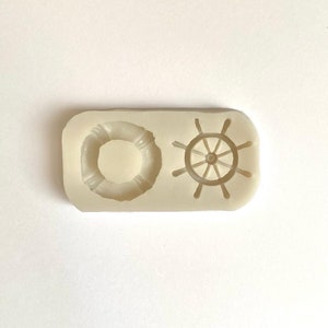 May include: A white silicone mold with two designs: a life preserver and a ship's wheel.