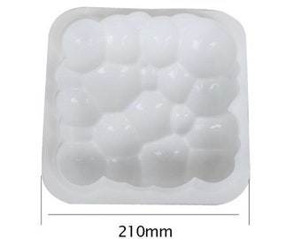 May include: White plastic mould with a bubble design, measuring 210mm in diameter. The mould is designed for making soap or other crafts.