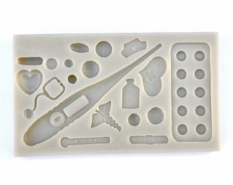 May include: Silicone mold with various medical themed shapes, including a thermometer, pills, a stethoscope, a bottle, a heart, and a first aid cross.