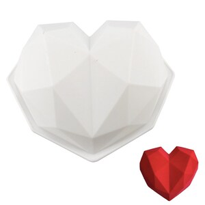 Può includere: Stampo in silicone bianco a forma di cuore con un design geometrico. Lo stampo è mostrato accanto a un cuore geometrico rosso.