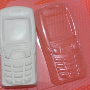Puede incluir: Un molde de plástico blanco para hacer un jabón o una vela con forma de teléfono móvil. El molde está abierto y muestra la parte delantera y trasera del teléfono.
