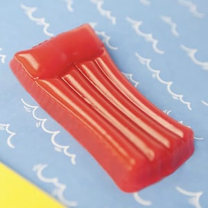 May include: A red inflatable pool float shaped like a traditional raft with three air chambers.