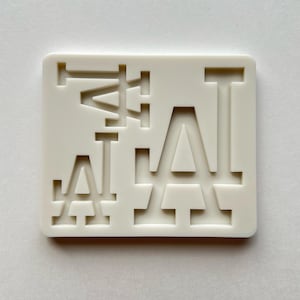 May include: Off-white square with the letters "LA" in a layered design. The letters are cut out of the square, creating a negative space effect. The design is simple and modern, with clean lines and a minimalist aesthetic.