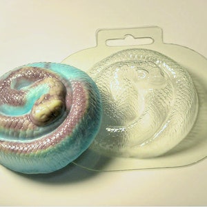 May include: A clear plastic mold of a coiled snake, with a blue and purple snake made of soap inside the mold.