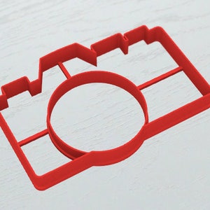 May include: Red plastic camera-shaped cookie cutter.