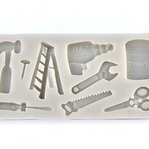 May include: A silicone mold with various tool shapes, including a hammer, screwdriver, ladder, drill, wrench, saw, scissors, and a paint can. The paint can has the word "PAINT" written on it.
