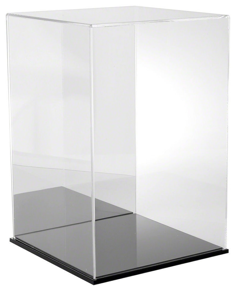 May include: A clear acrylic display case with a black base. The case is designed to protect and showcase collectibles.