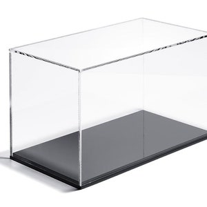 May include: A clear acrylic display case with a black base. The case is rectangular and has a removable lid.