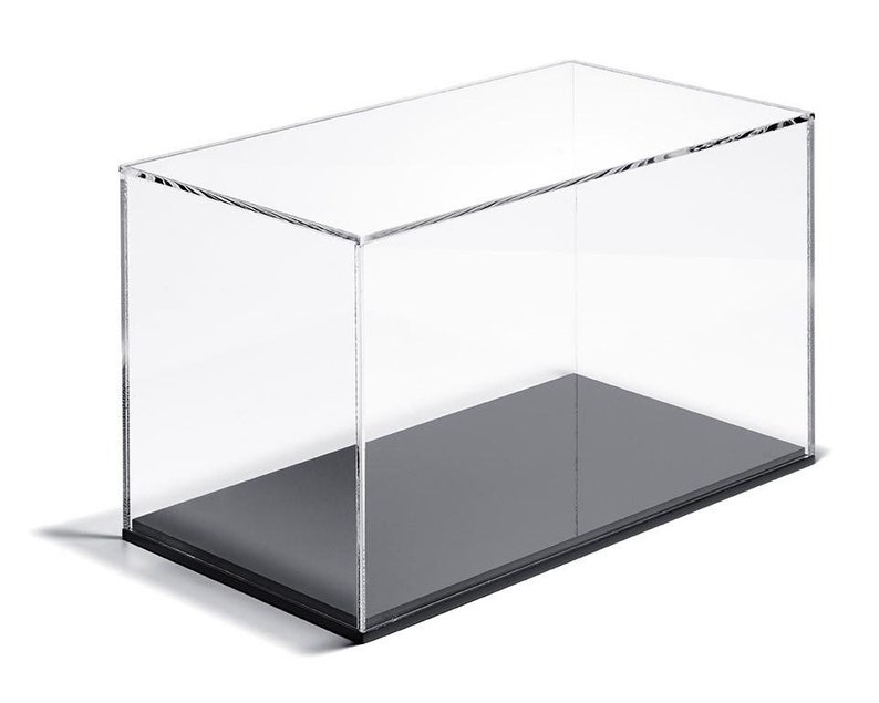 May include: A clear acrylic display case with a black base. The case is rectangular and has a removable lid.