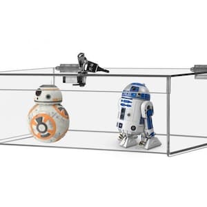 May include: A clear acrylic display case with a lock and two Star Wars action figures inside. The figures are R2-D2 and BB-8.
