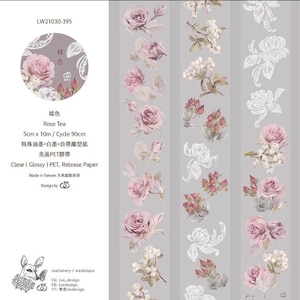 May include: A roll of washi tape with a floral design featuring pink roses and white lace. The tape is 5 cm wide and 10 metres long. The text on the tape reads "Rose Tea" and "Clear (Glossy) PET, Release Paper".