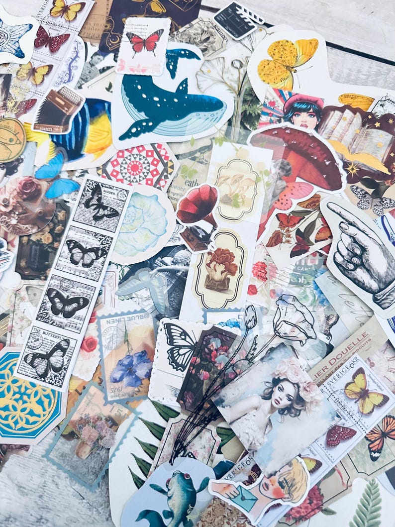 May include: A collection of colorful and whimsical stickers featuring butterflies, flowers, a whale, a mushroom, a hand pointing, and other nature-inspired designs. The stickers are perfect for adding a touch of personality to journals, planners, laptops, and other surfaces.