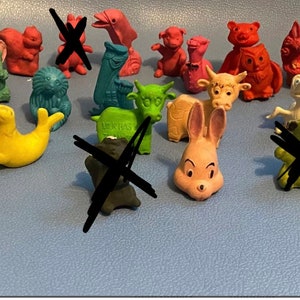 May include: A collection of colorful animal eraser toppers, including a monkey, seal, cow, rabbit, and more. These eraser toppers are perfect for adding a touch of fun to any desk or pencil case.