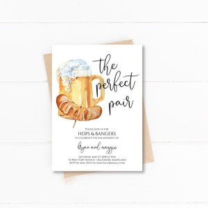May include: Watercolor invitation with a beer mug and sausage illustration. The text reads "the perfect pair" and invites guests to celebrate the engagement of Bryan and Maggie. The invitation is on a white background.