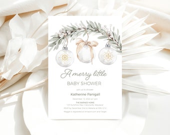 May include: A white baby shower invitation with a watercolor illustration of a green branch with three clear glass ornaments with gold snowflake designs. The text reads "A merry little baby shower" and includes the details of the event, including the date, time, location, and RSVP information.