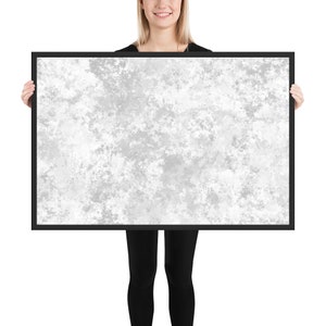 May include: A black framed canvas print with a white and gray abstract design. The design resembles a cloudy sky or a textured surface.