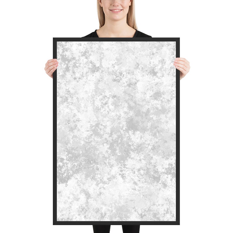 May include: A framed print with a white and gray abstract design. The design resembles a cloudy sky or a textured surface.