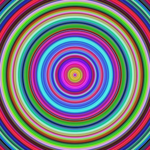 May include: Abstract concentric circles in a rainbow of colors, starting with yellow and red on the outside and ending with a small yellow circle in the center.