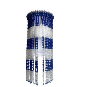 May include: A blue and white beaded headpiece with a fringe of clear beads.