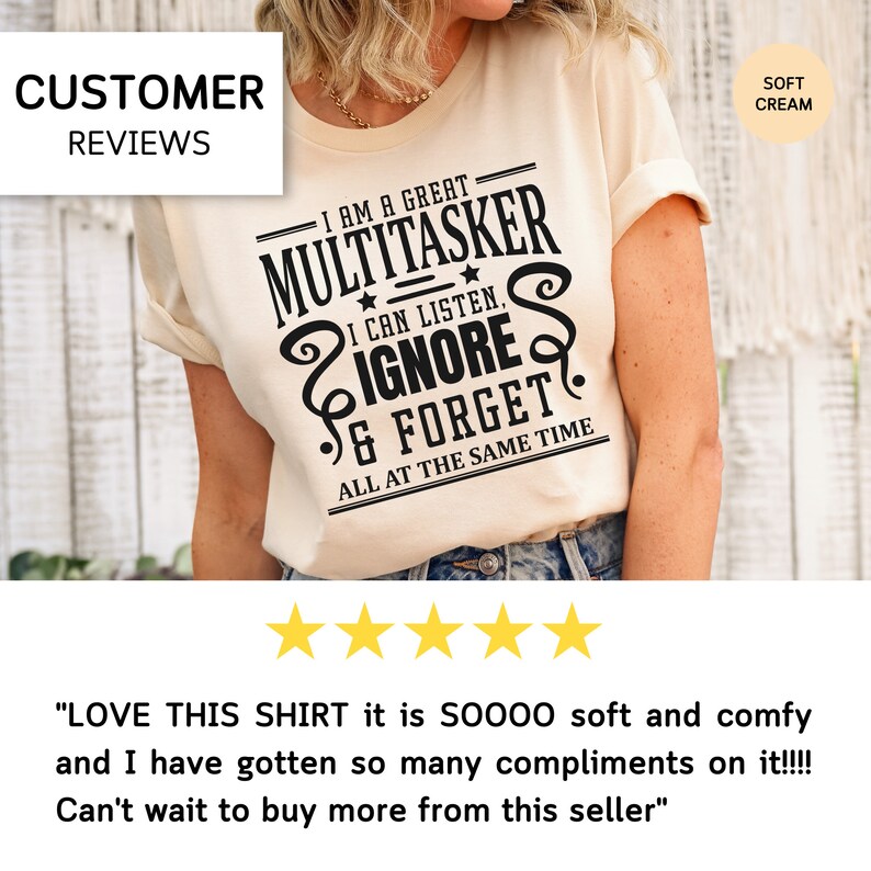 May include: A cream colored t-shirt with black text that reads "I am a great multitasker I can listen, ignore & forget all at the same time". The shirt is being modeled by a person. The text is in a vintage style font. Five yellow stars are below the image.