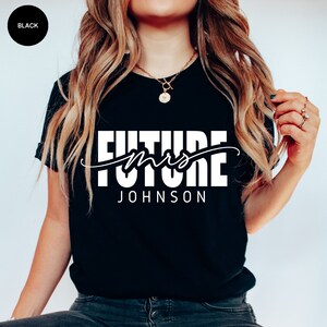 May include: Black t-shirt with white text that reads "Future Mrs. JOHNSON"