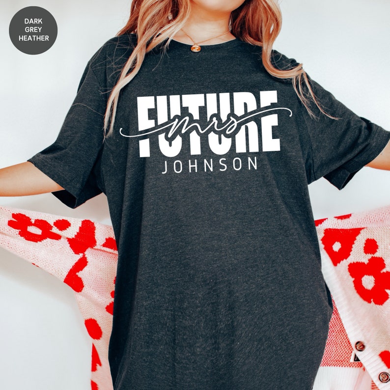 May include: Dark grey heather t-shirt with the text "Future Mrs. JOHNSON" in white.