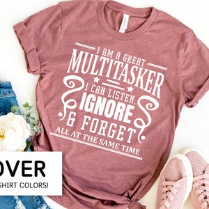 May include: A mauve t-shirt with white text that reads "I am a great multitasker. I can listen, ignore & forget all at the same time".