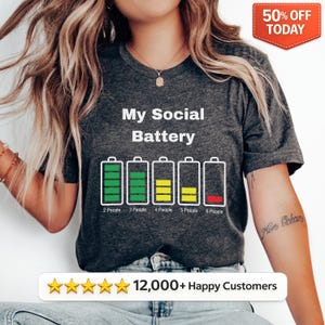 May include: Dark gray t-shirt with the text "My Social Battery" and a graphic of battery levels. The battery graphic shows levels for 2, 3, 4, 5, and 6 people. A red "50% OFF TODAY" banner is in the top right.