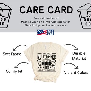 May include: A beige t-shirt with a black graphic that reads "I am a great multitasker. I can listen, ignore & forget all at the same time". The shirt is shown on a white background with arrows pointing to the words "Soft Fabric", "Comfy Fit", "Durable Material", and "Vibrant Colors".