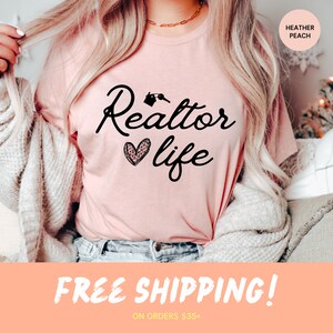 May include: A pink t-shirt with the text "Realtor life" in black script with a house key graphic and a pink and black leopard print heart. The text "Heather Peach" is in the top right corner of the image.