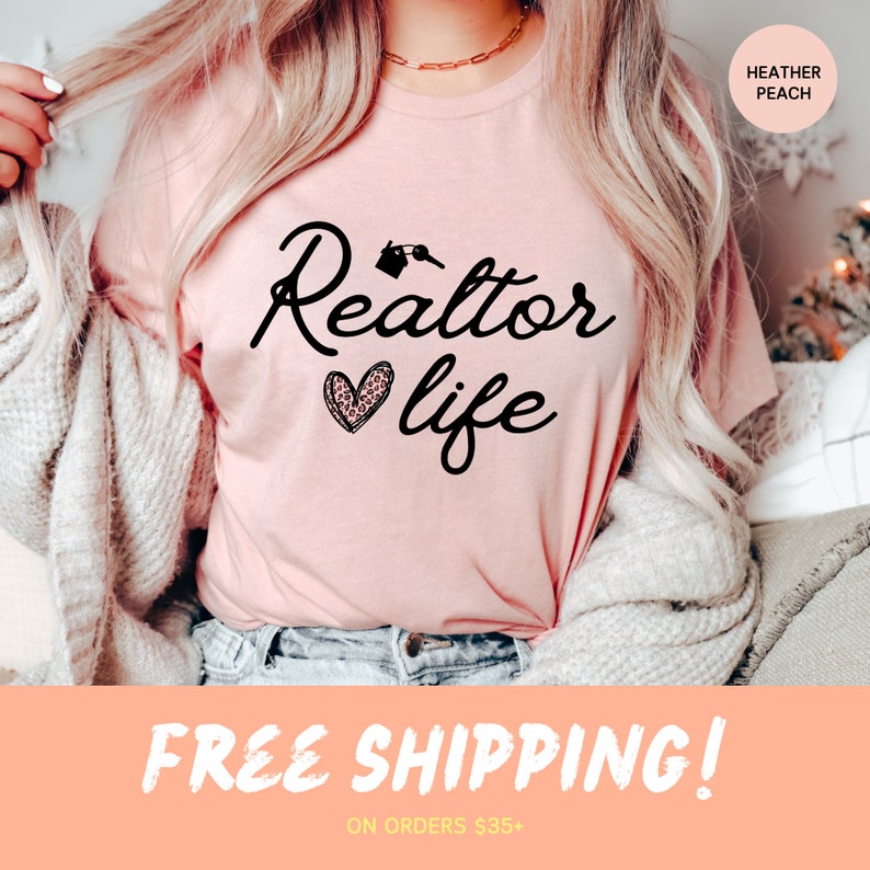 May include: A pink t-shirt with the text "Realtor life" in black script with a house key graphic and a pink and black leopard print heart. The text "Heather Peach" is in the top right corner of the image.