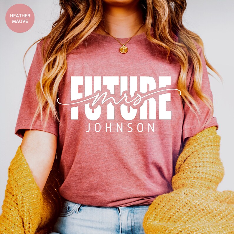 May include: A heather mauve t-shirt with the text "Future Mrs. JOHNSON" in white.