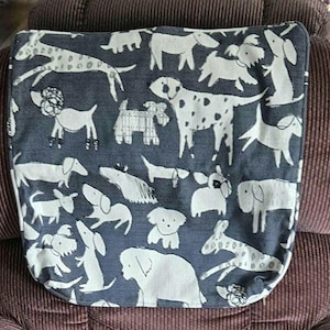 May include: A square fabric cushion cover featuring a dark gray background with a repeating pattern of various white line-drawn dogs in different breeds and poses, including spotted, long-haired, and small terrier-like canine illustrations.
